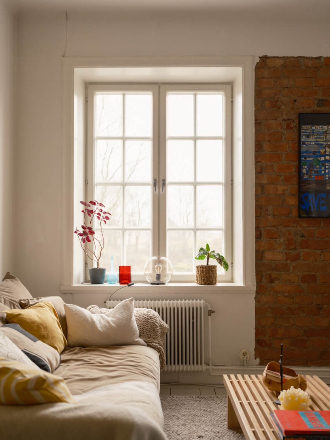 A Studio Apartment with an Exposed Brick Wall 4 large window sitting area