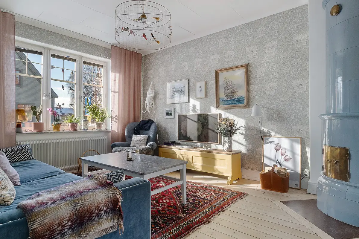 A Charming Early 20th-Century Family Home in Sweden 1 living room blue fireplace wallpaper