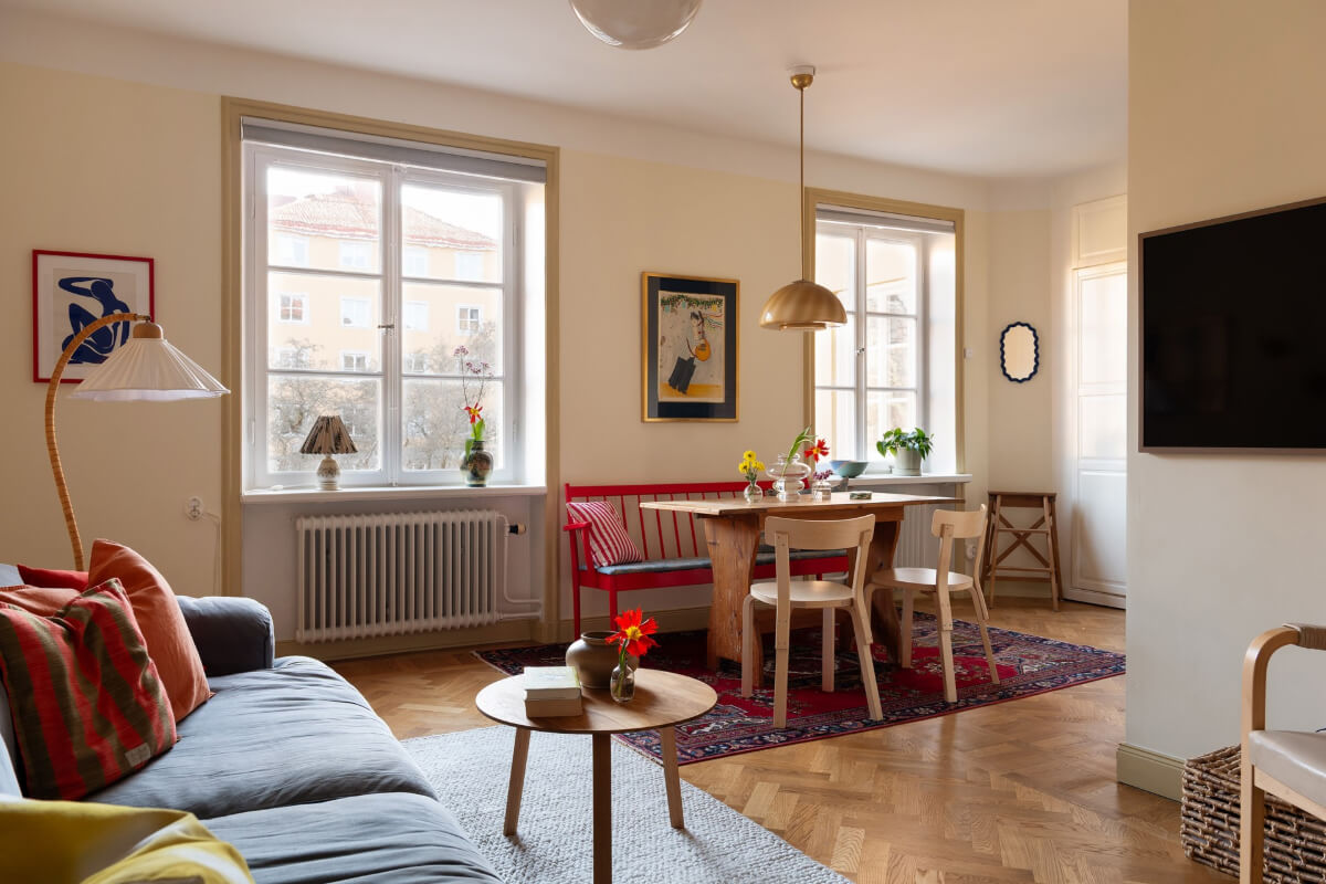 A Swedish Apartment with Period Features and Charming Color Pops 4 living room herringbone parquet floor