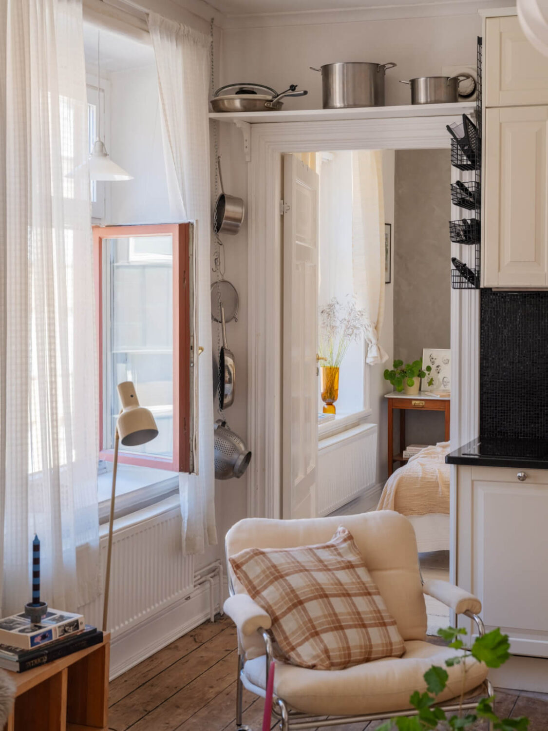 A Small Apartment with Rustic Floorboards and Beige Walls 15 living room kitchen detail storage