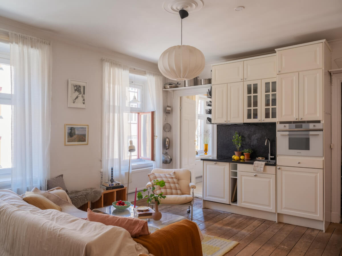 A Small Apartment with Rustic Floorboards and Beige Walls 3 living room kitchen rustic floorboards