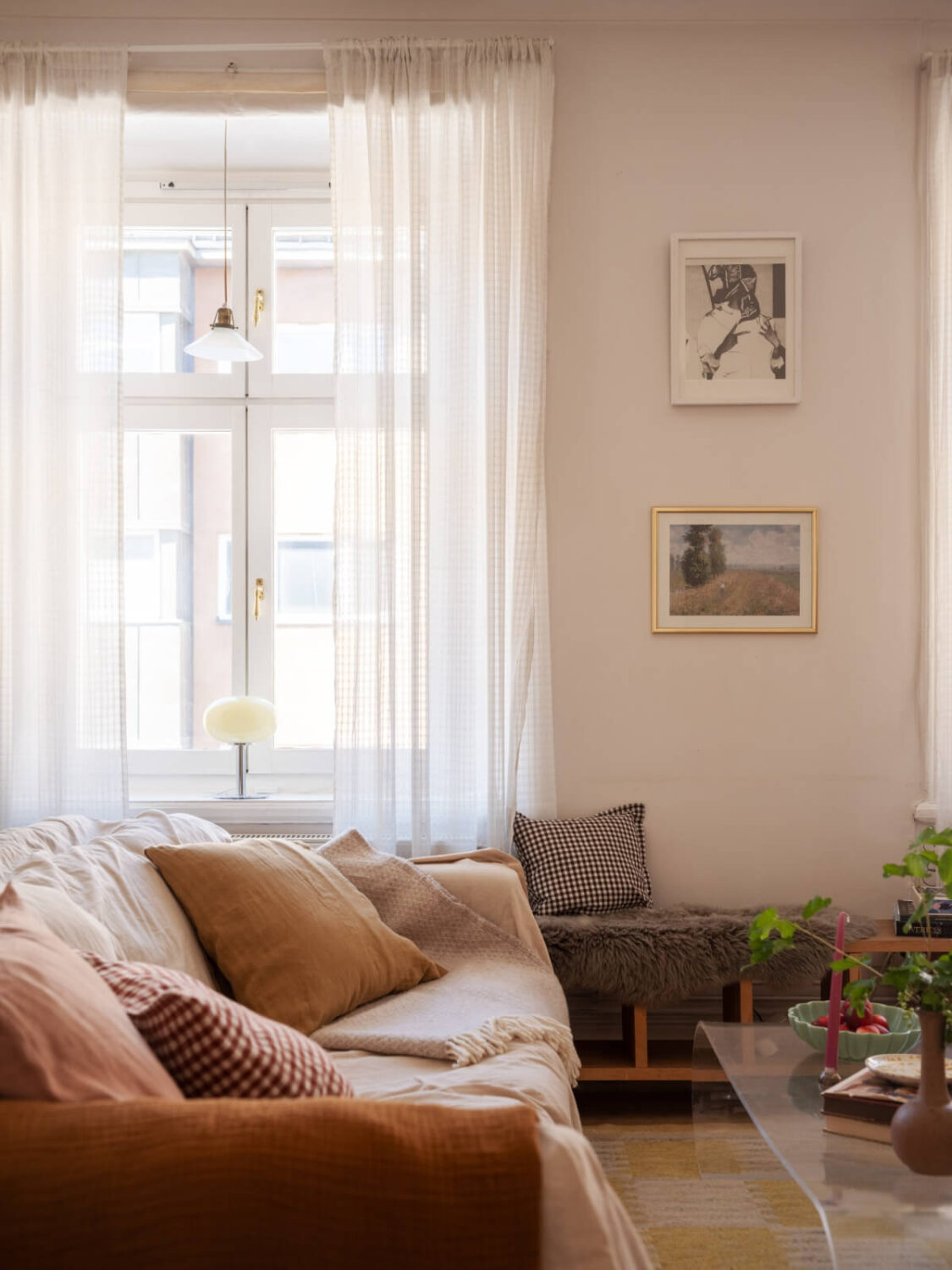A Small Apartment with Rustic Floorboards and Beige Walls 8 living room large window