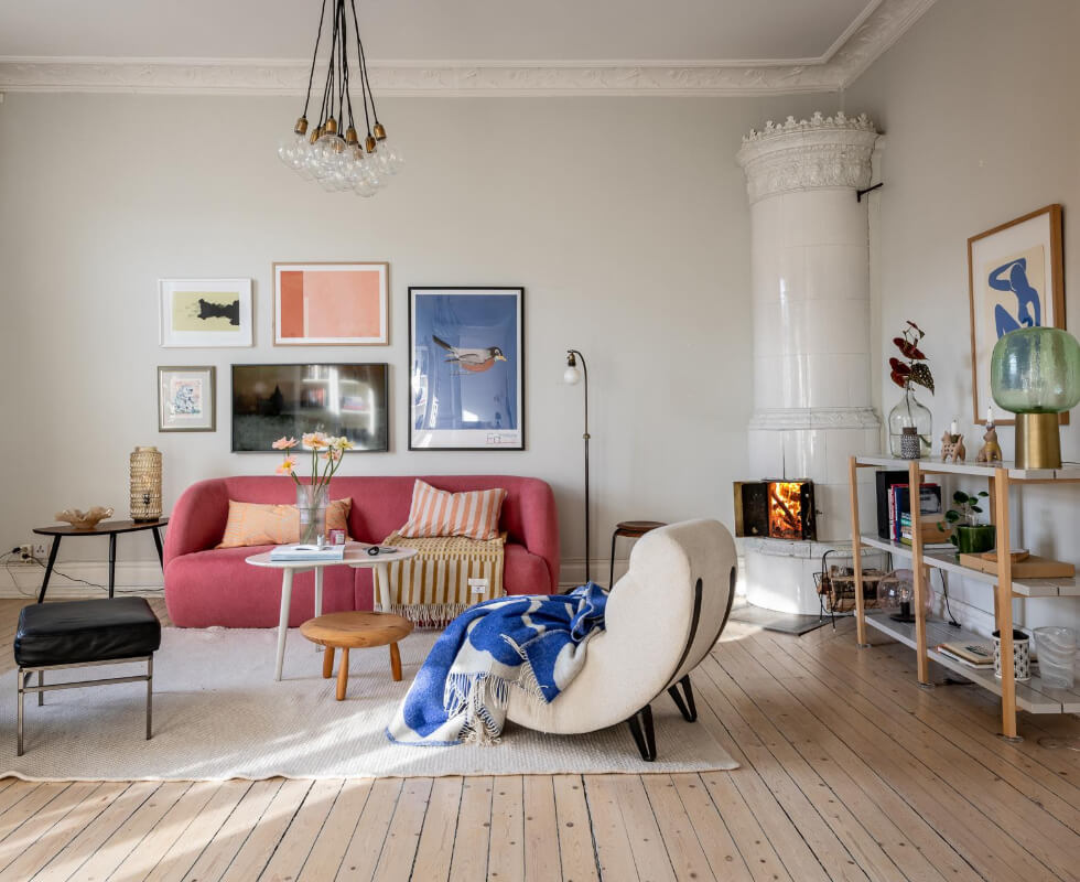 A Light and Spacious Apartment with a Cozy Social Kitchen 1 living room pink sofa fireplace