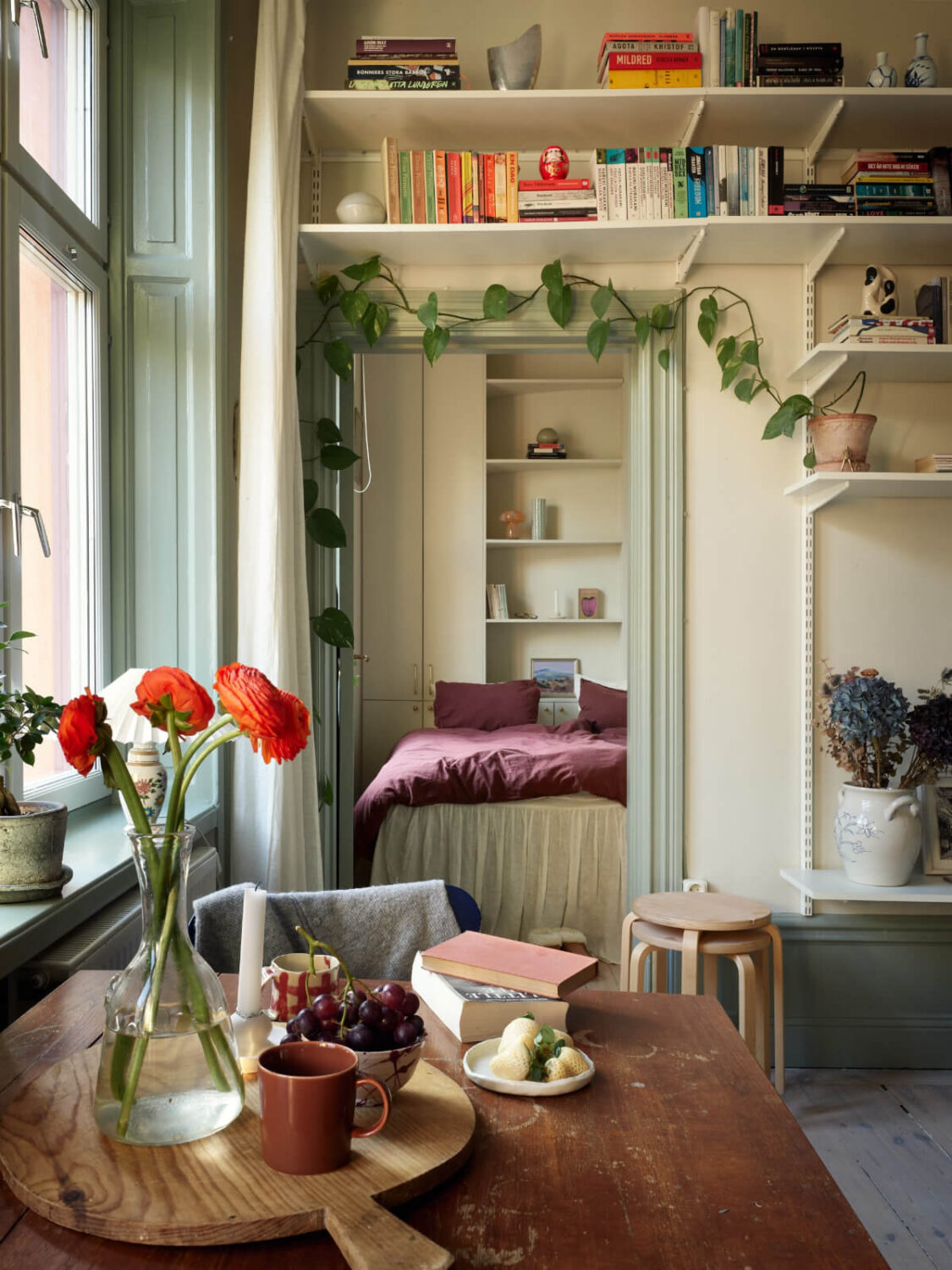 A Muted Color Palette and Smart Storage in a Small Stockholm Apartment 8 living room view into bedroom