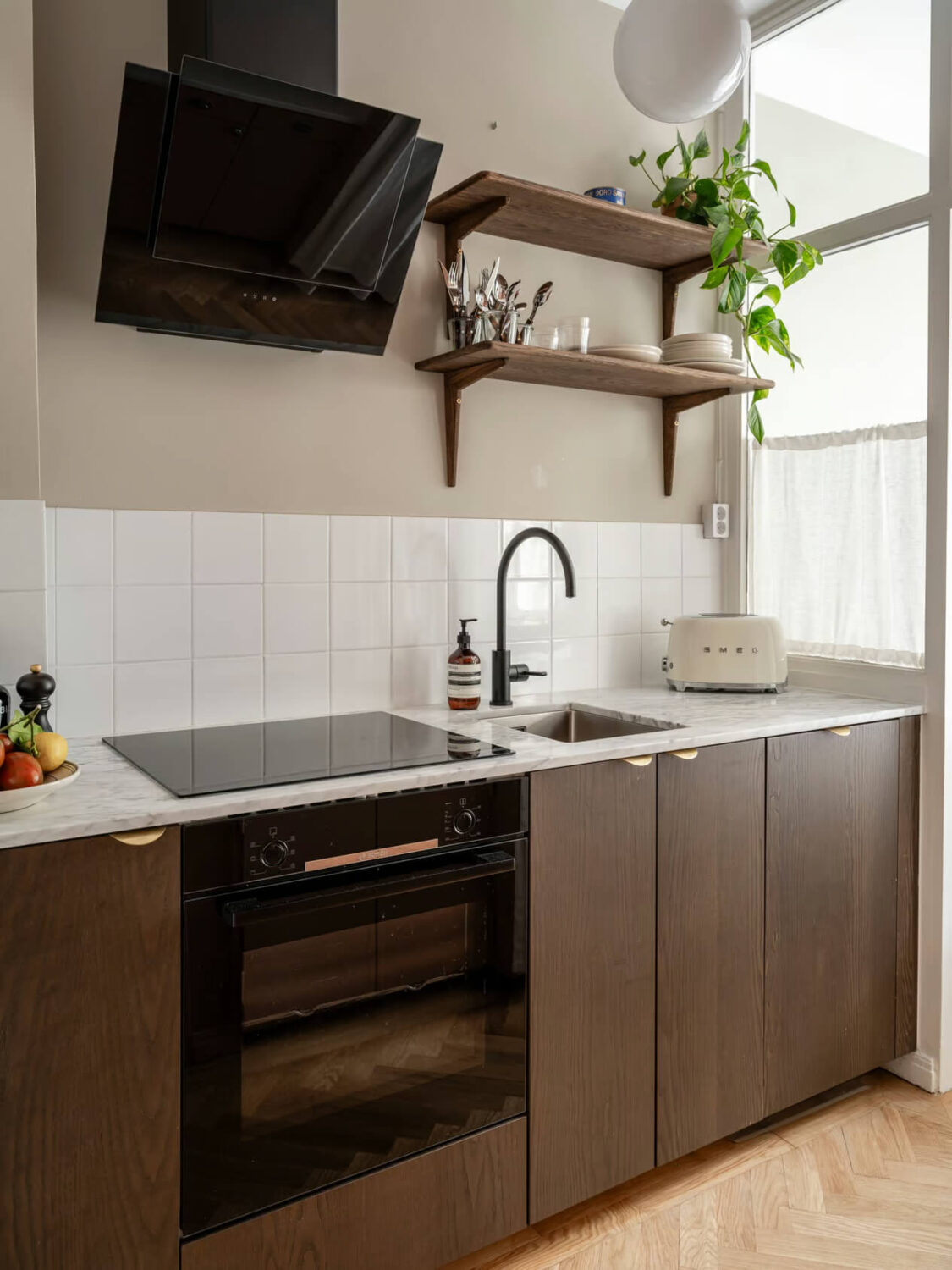 A Charming Small Apartment with a Cozy Bedroom Niche 11 modern kitchen walnut cabinets marble countertop