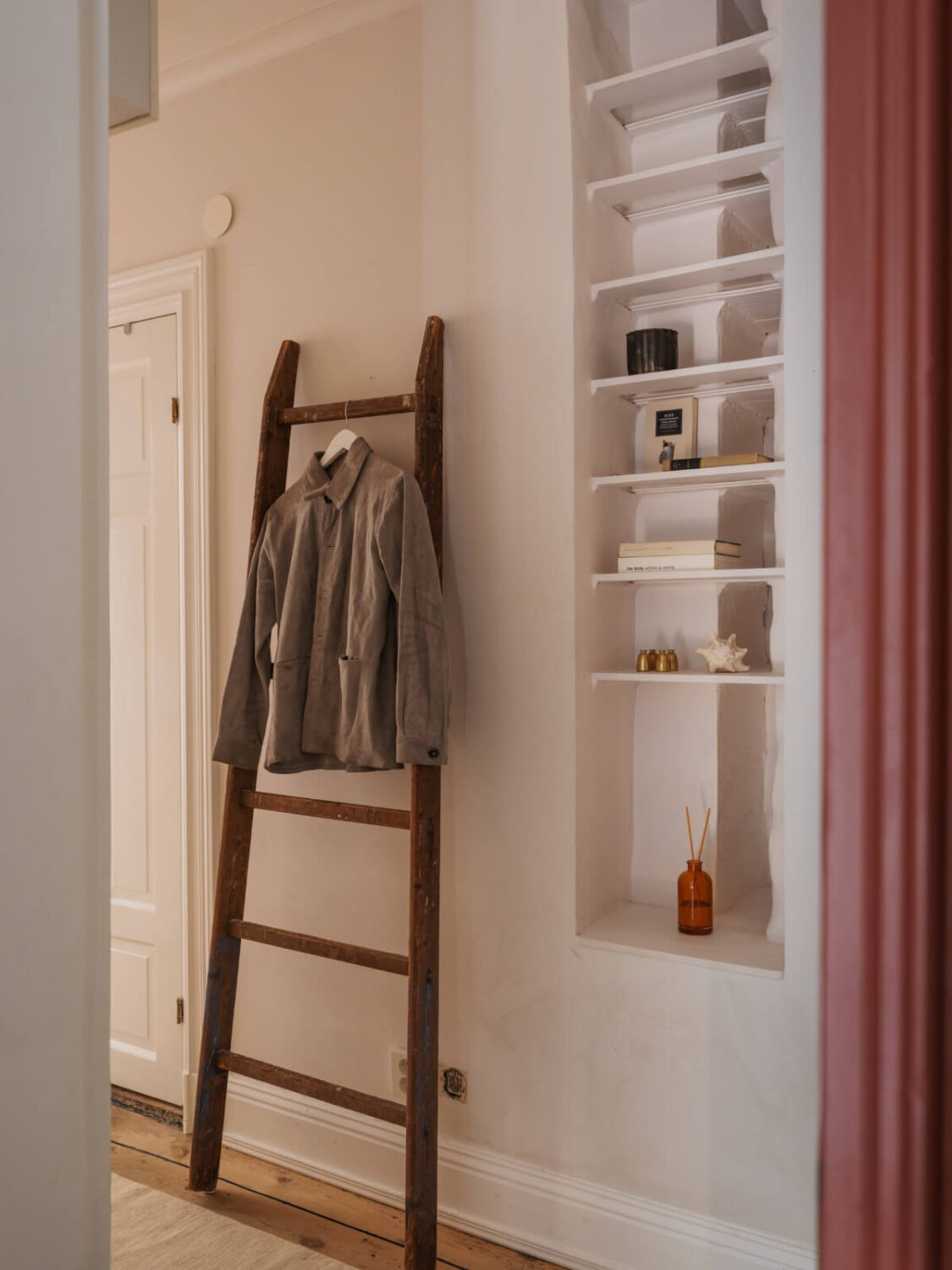 A Small Apartment with Rustic Floorboards and Beige Walls 20 niche with shelves