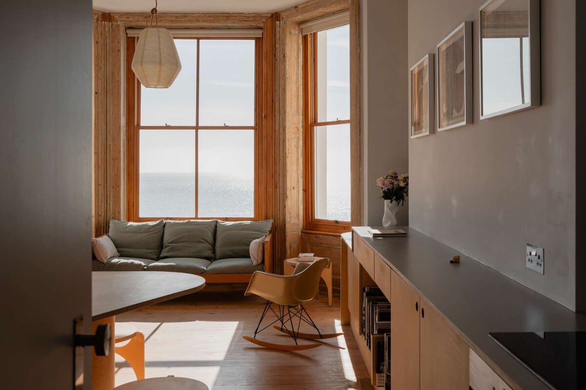 Bespoke Furniture in a Restored Seaside Apartment in England 5 open plan living space large window custom furniture