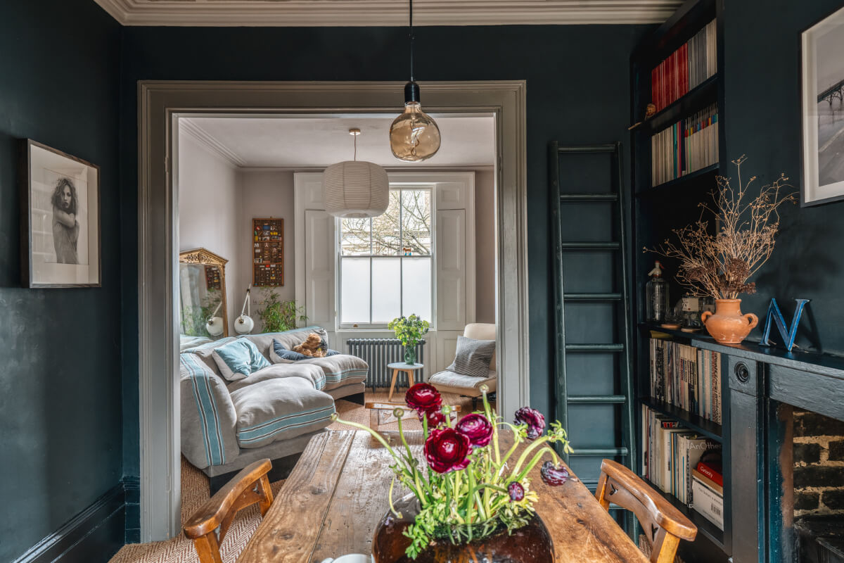 A Cozy Victorian Home Painted in Moody Blue and Gray Tones 5 open-plan living space with rustic dining table