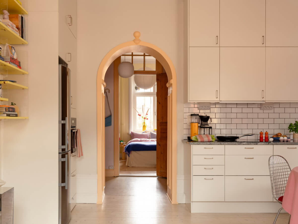 Cheerful Color Accents in a One-Bedroom Stockholm Apartment 12 painted arch doorway to hall