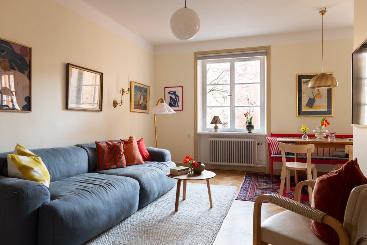 A Swedish Apartment with Period Features and Charming Color Pops 2 pale yellow walls living room color accents