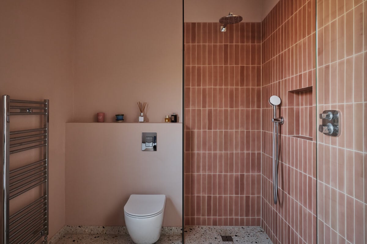 A Beautiful Extended Edwardian House Blends Period Features with Modern Design 24 pink bathroom terrazzo floor shower with storage niche