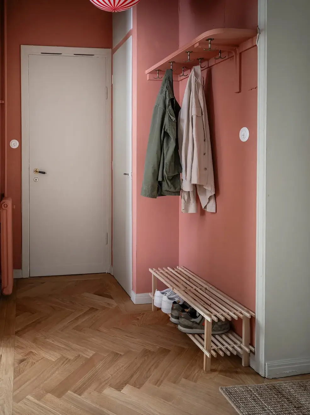 A Charming Small Apartment with a Cozy Bedroom Niche 16 pink hall coat and shoe storage