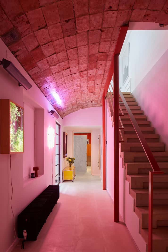 A Contemporary Architect-Designed Duplex Within a Grand Victorian Terrace 14 pink light basement hallway