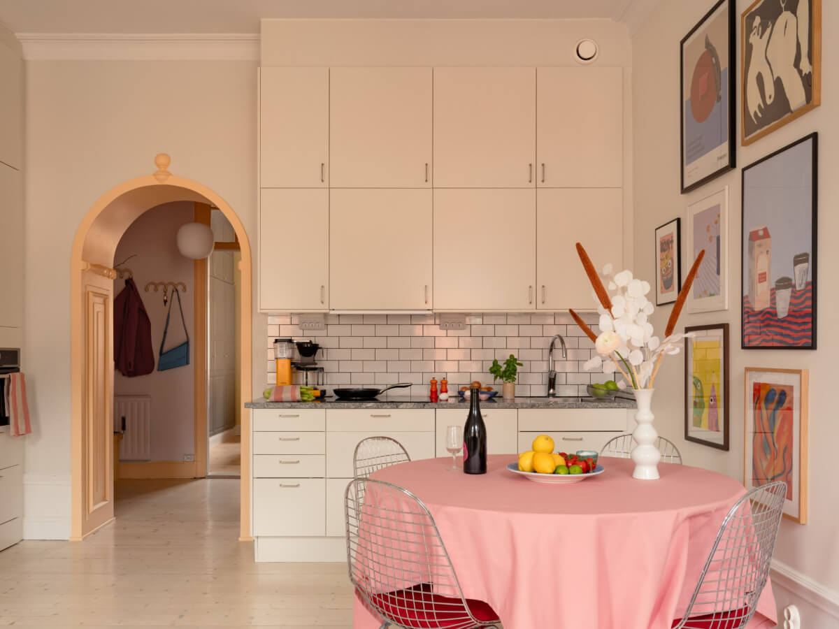 Cheerful Color Accents in a One-Bedroom Stockholm Apartment 7 pink table cloth white kitchen