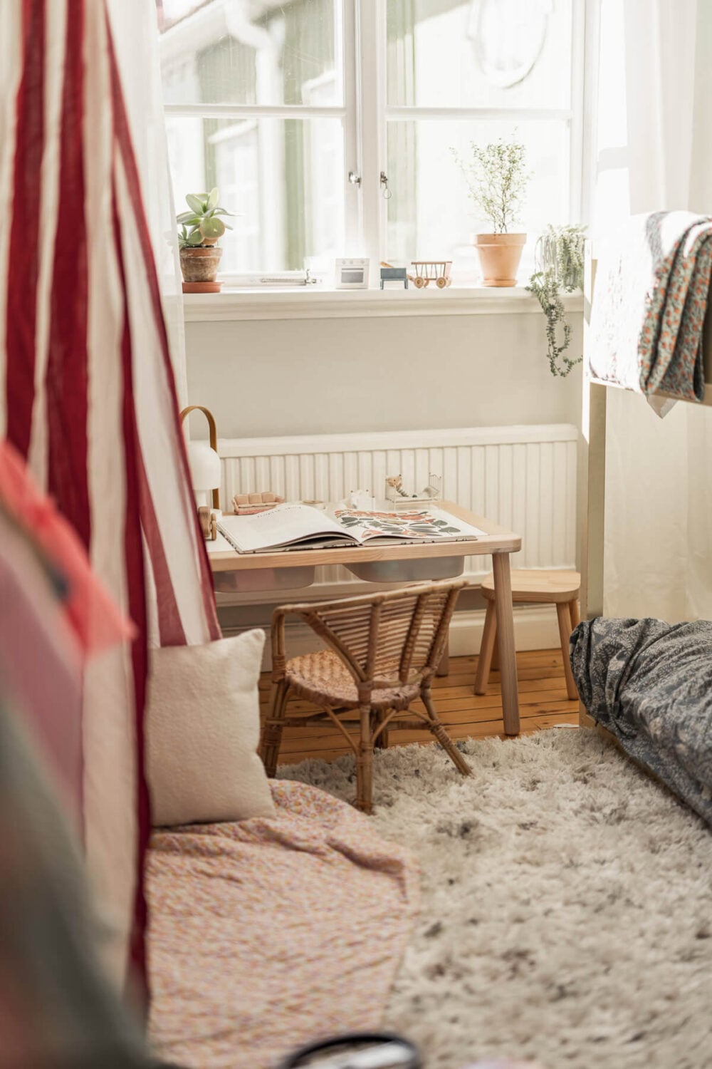A Swedish Duplex Apartment Inspired by A Danish Summer House 37 play area with rug and small desk