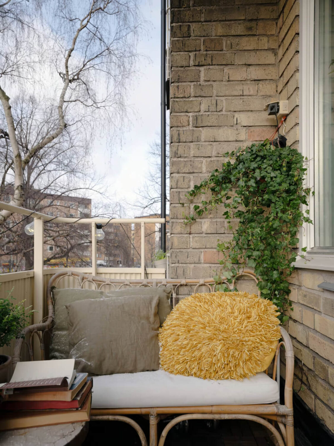 Limewash Walls in Muted Tones in a Swedish Apartment 14 rattan bench balcony