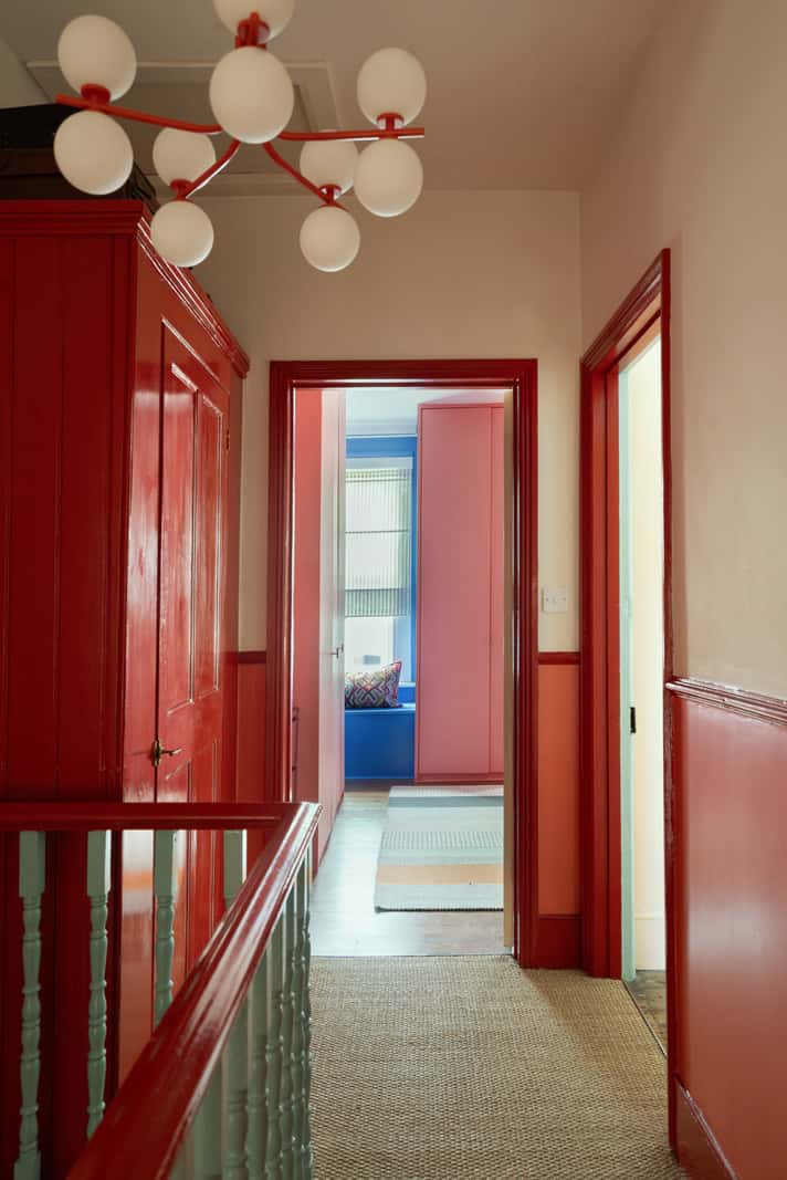 A Colorful Home with a Gold Extension in North London 20 red joinery hall
