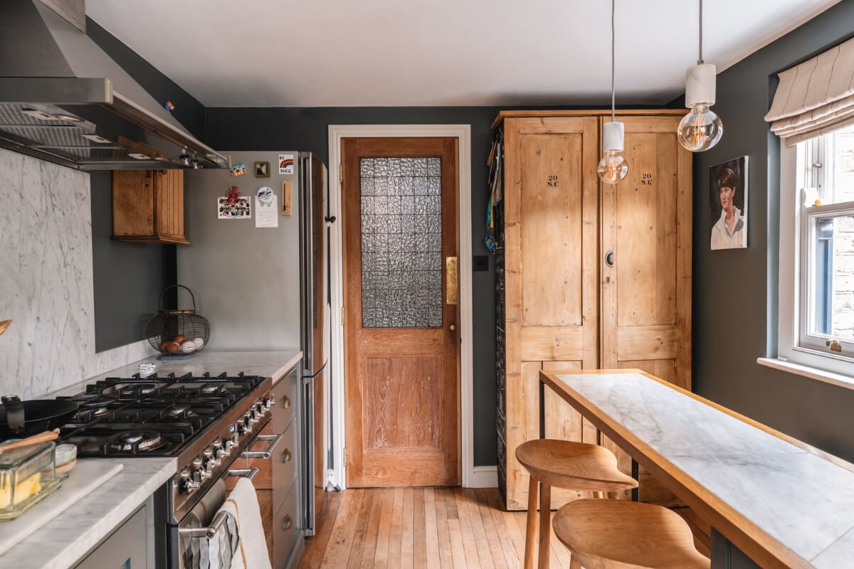 A Cozy Victorian Home Painted in Moody Blue and Gray Tones 13 rustic wooden door kitchen