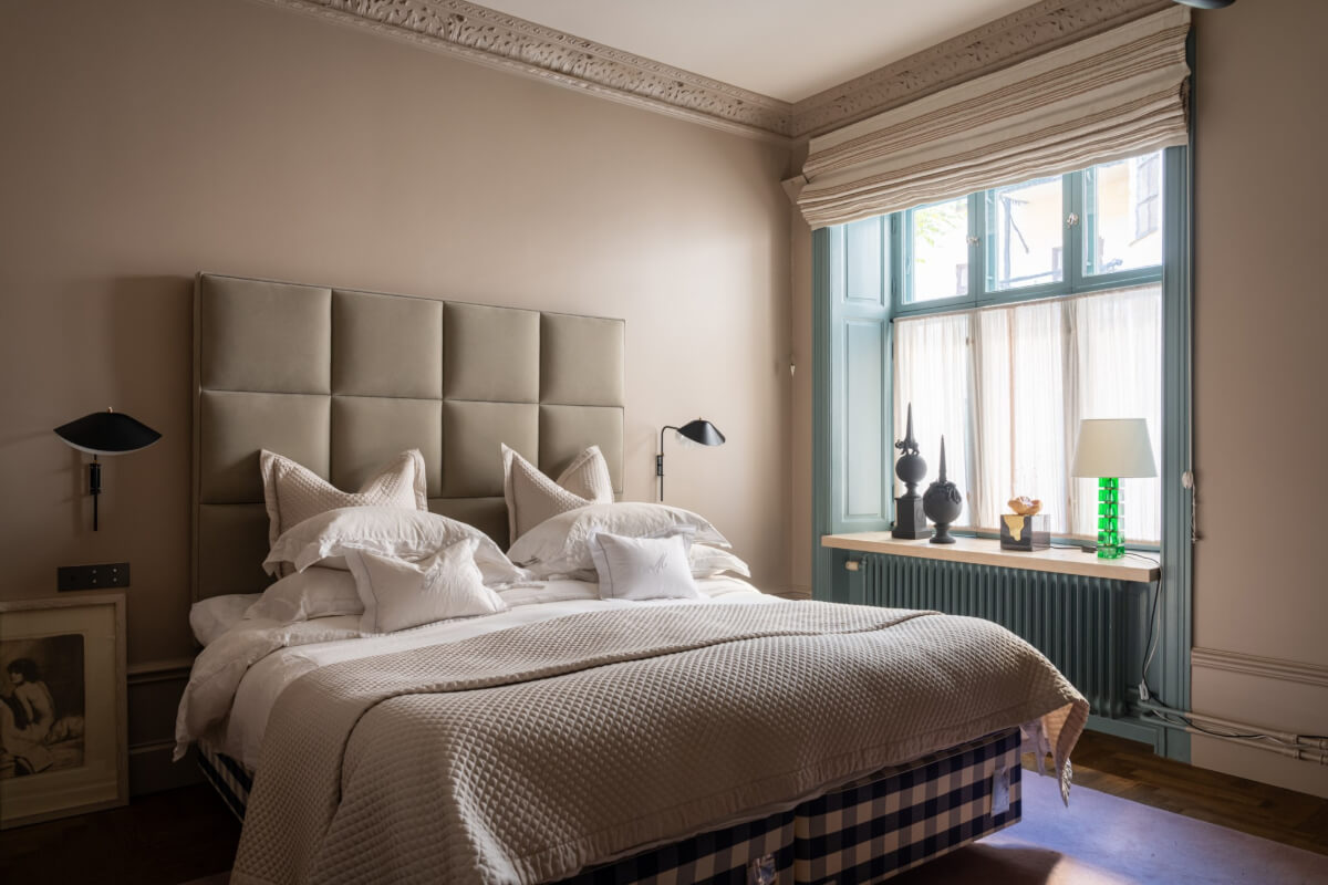 Hotel-Style Interiors in a Late 19th Century Apartment in Stockholm 15 serene bedroom blue window frame