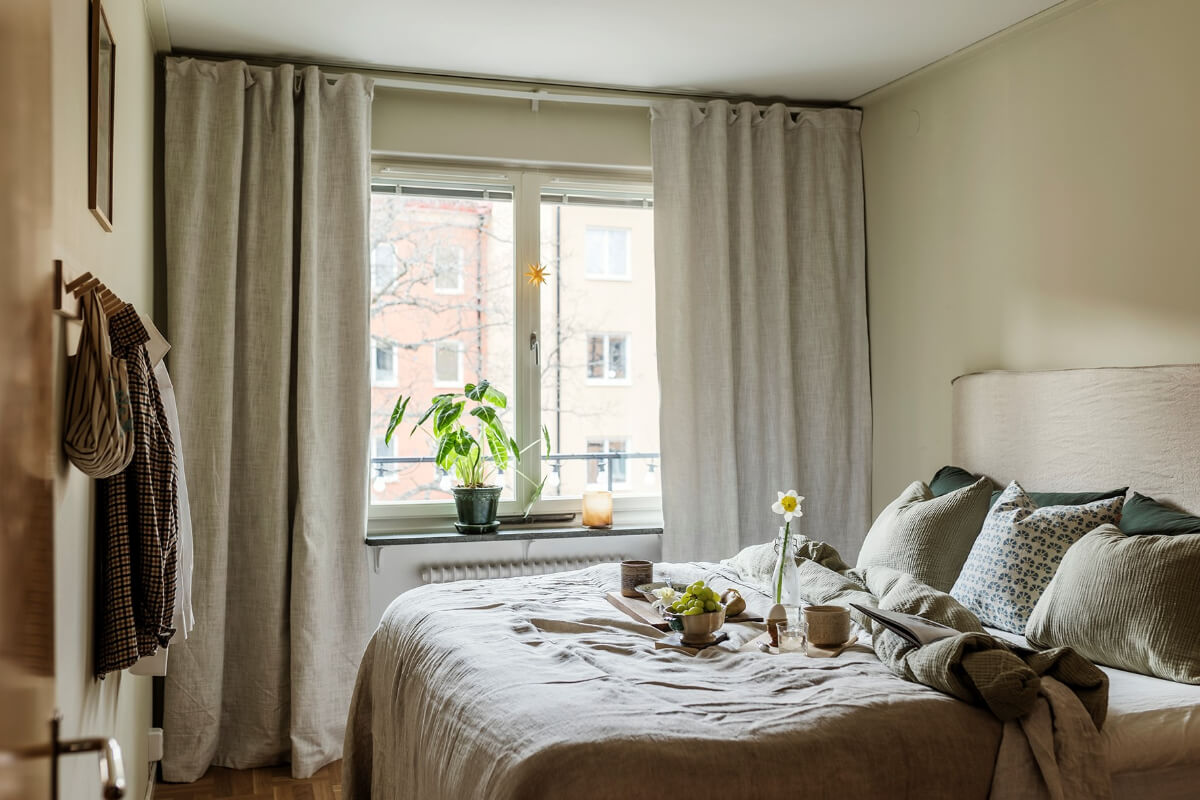 A Two-Bedroom Apartment with the Original Midcentury Kitchen 11 serene bedroom gray linen curtain