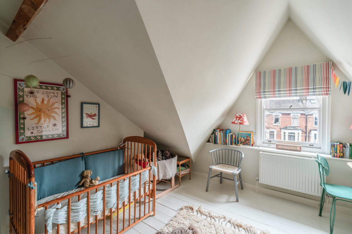 A Cozy Two-Bedroom Attic Apartment in a Victorian Townhouse 13 slanted ceiling nursery white floorboards