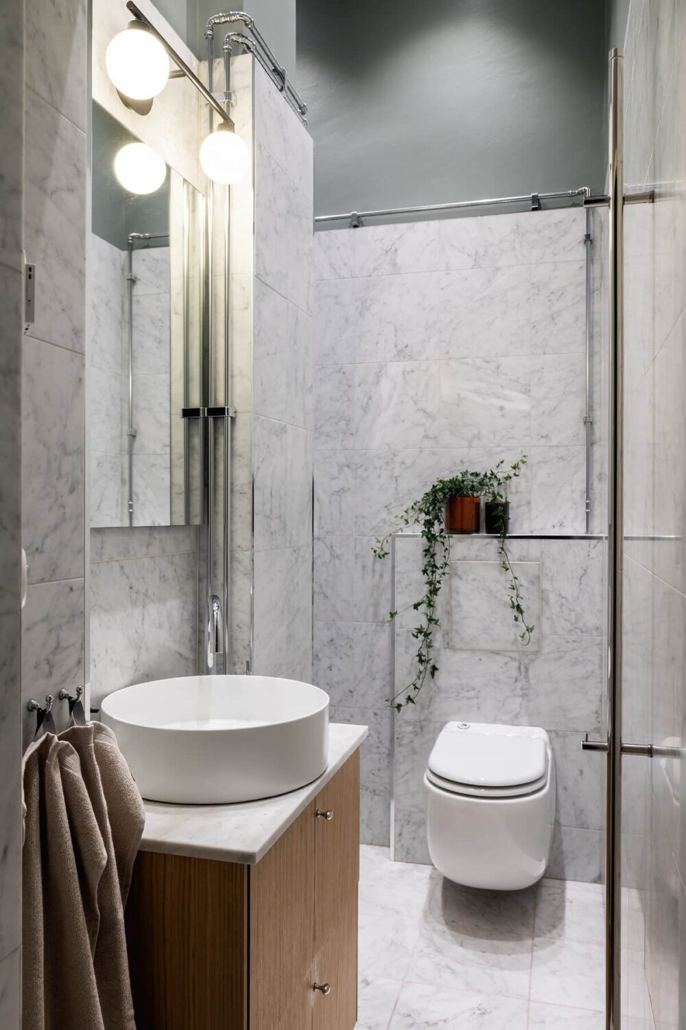 A Luxurious Stockholm Apartment with Period Features and a Blue Fireplace 16 small bathroom marble tiles green walls