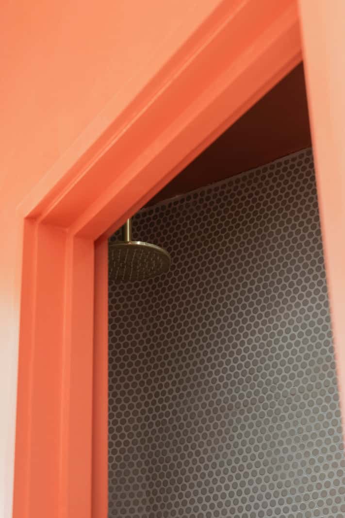 Bespoke Furniture in a Restored Seaside Apartment in England 15 small bathroom shower orange wall