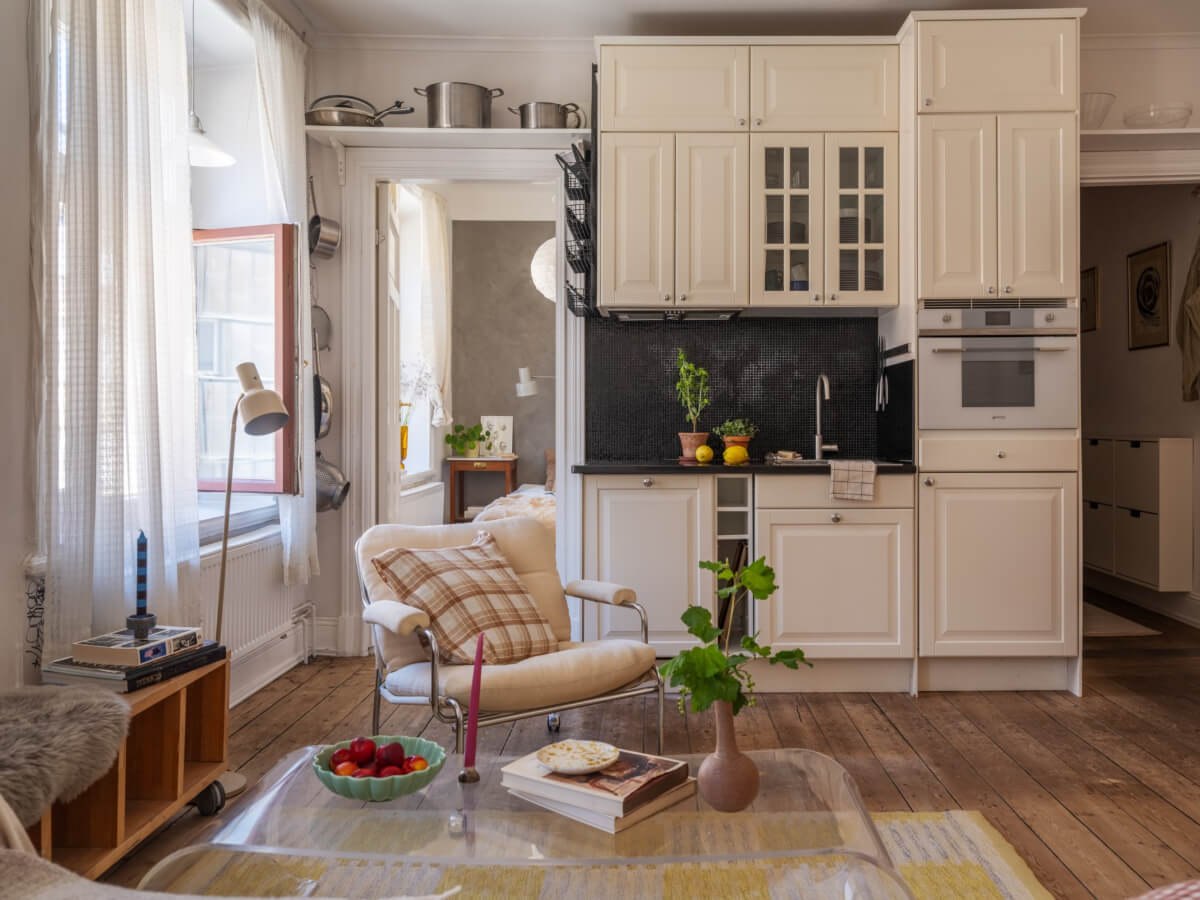 A Small Apartment with Rustic Floorboards and Beige Walls 12 small kitchen shelf above door