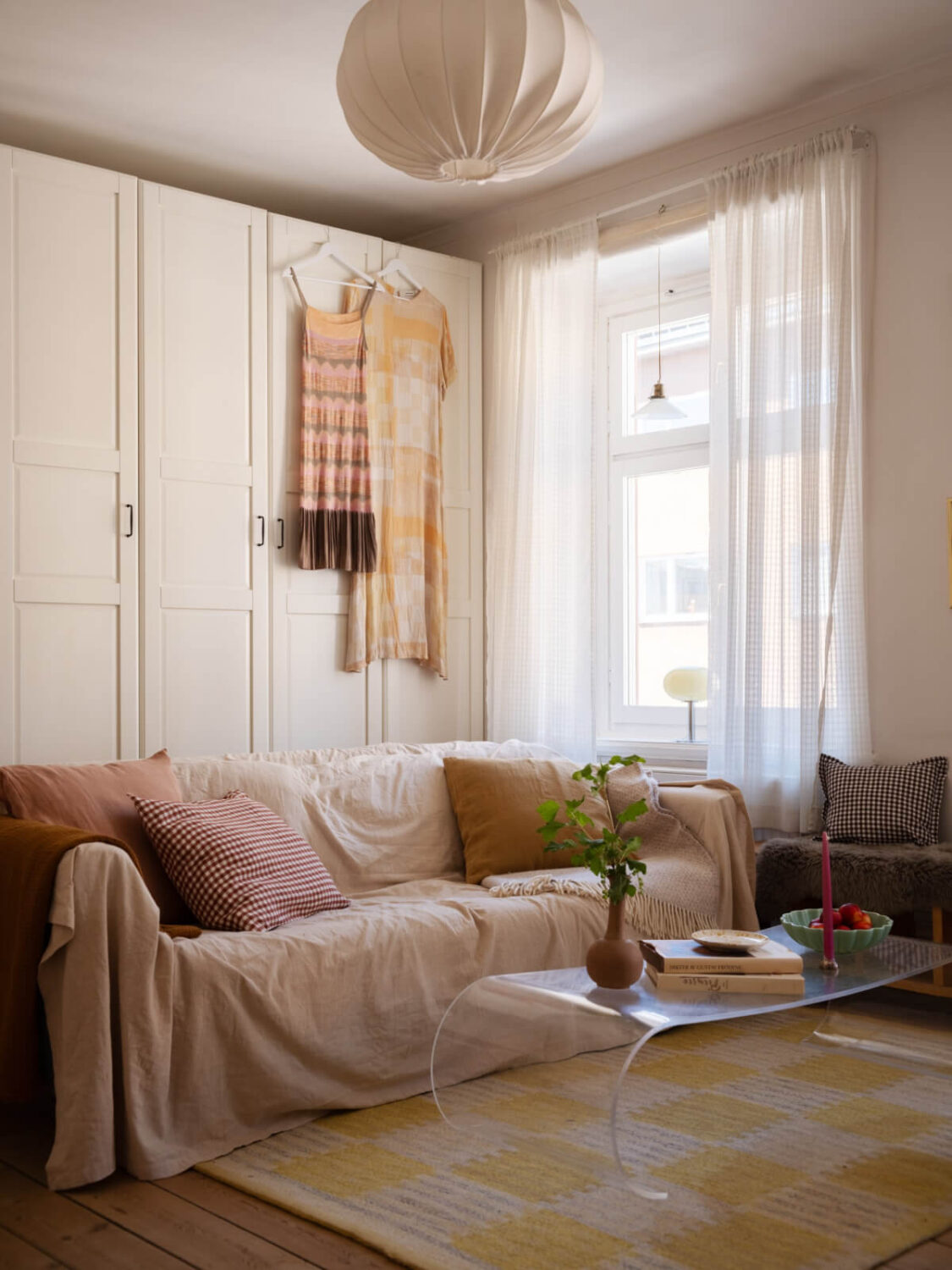 A Small Apartment with Rustic Floorboards and Beige Walls 4 small living room yellow rug wardrobes