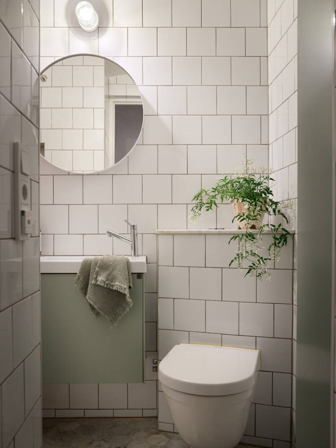 Revisiting a Bright Scandi Apartment with a Gray Kitchen 25 small white bathroom