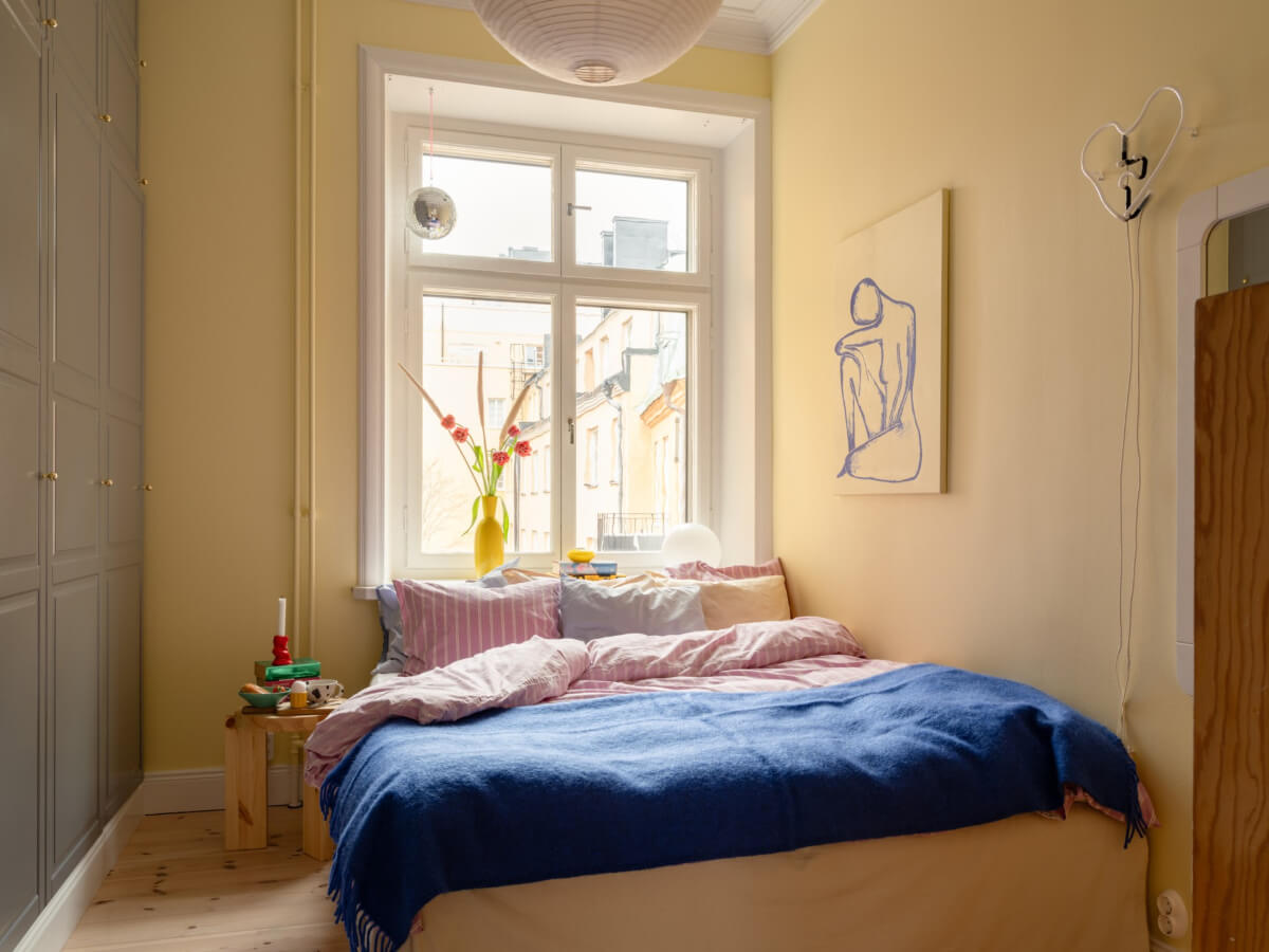 Cheerful Color Accents in a One-Bedroom Stockholm Apartment 15 small yellow bedroom built in wardrobes