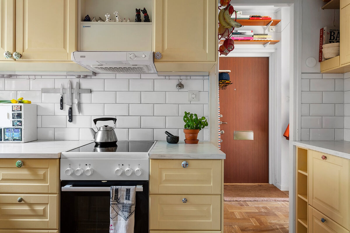 A Colorful 1940s Apartment in Stockholm 8 small yellow kitchen