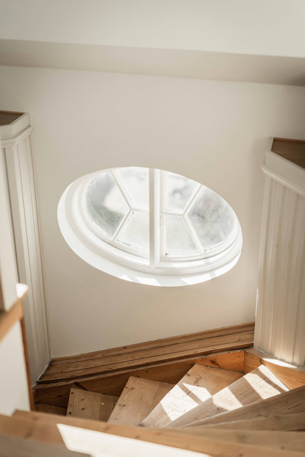 A Swedish Duplex Apartment Inspired by A Danish Summer House 17 staircase-round-window