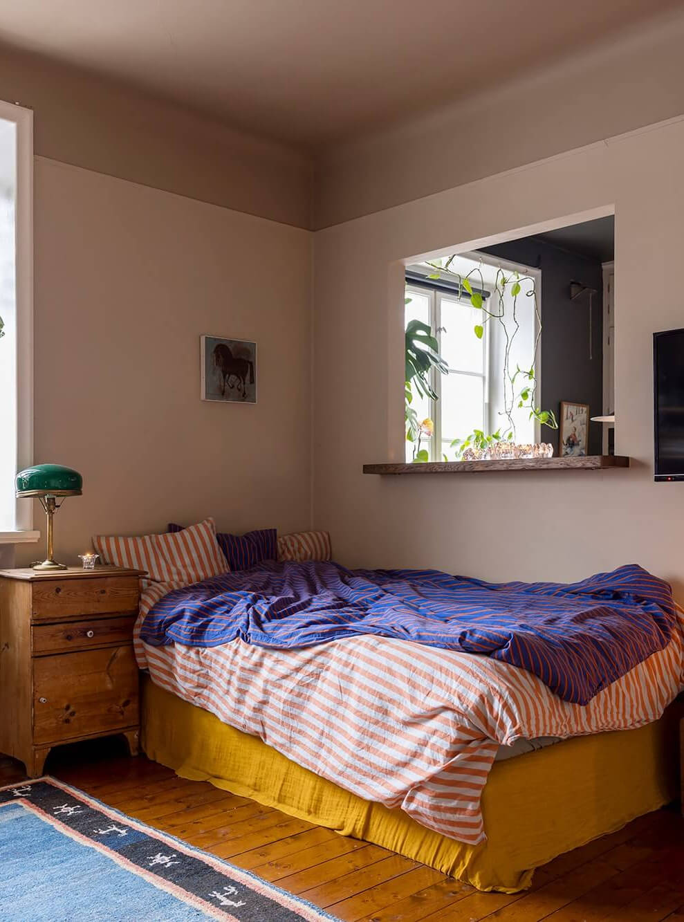 A Cozy Studio Apartment in a 1930s Building 4 striped bedding studio apartment