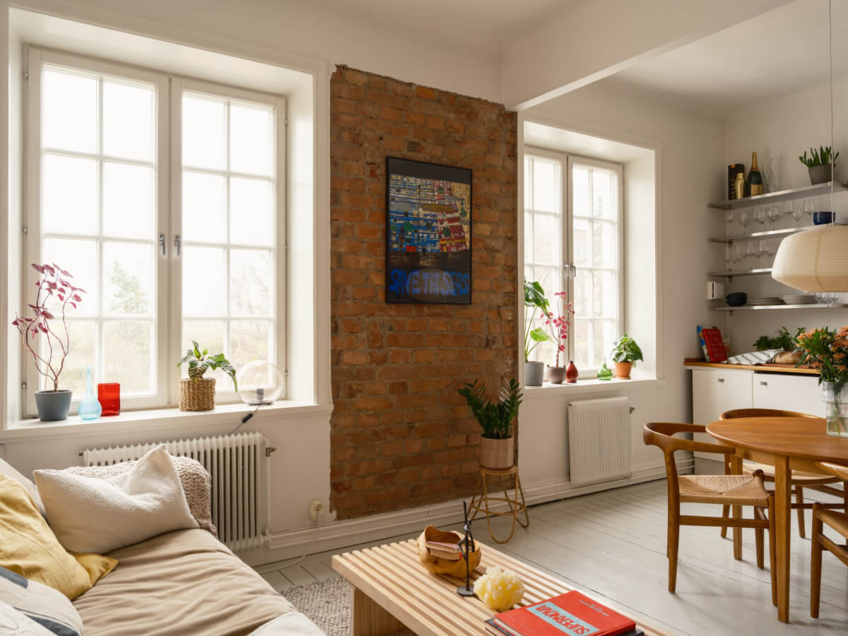 A Studio Apartment with an Exposed Brick Wall 6 studio brick wall white kitchen