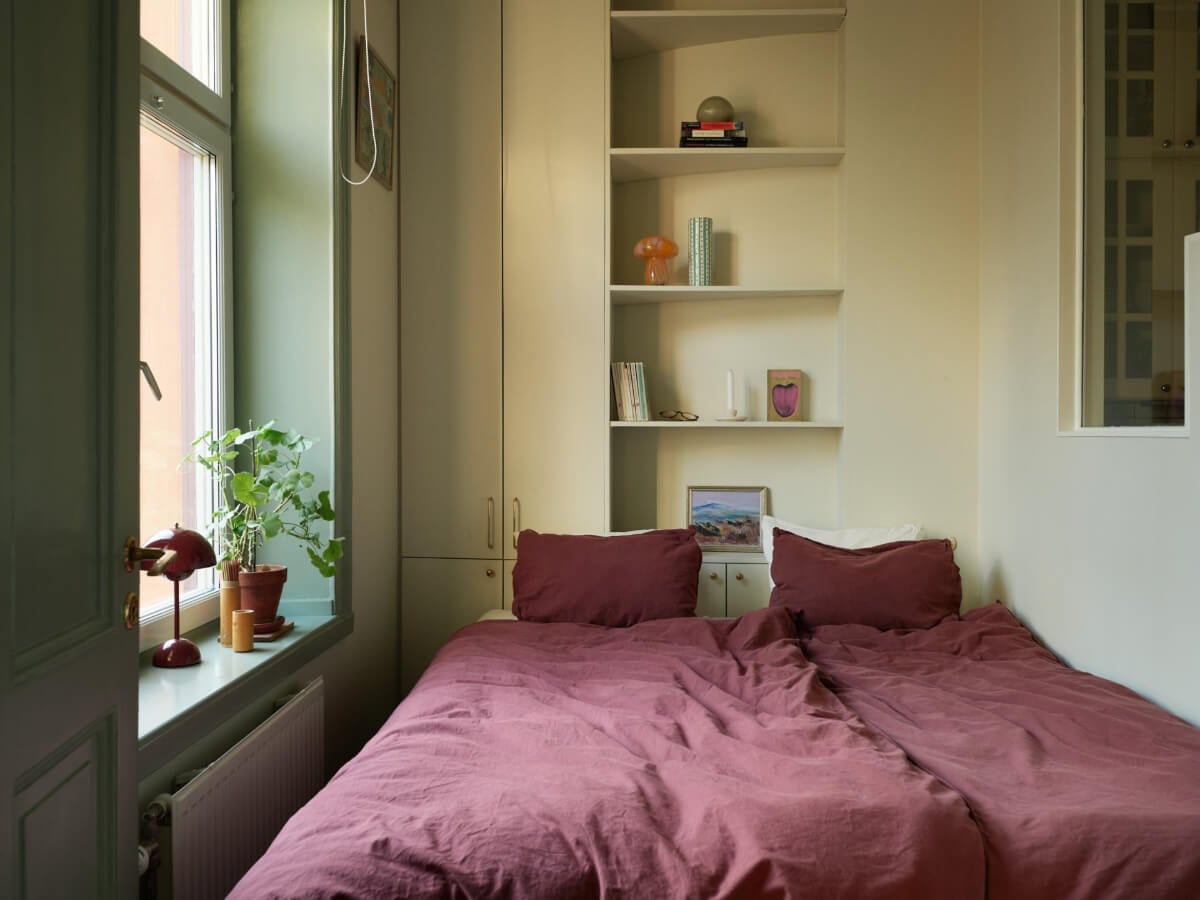 A Muted Color Palette and Smart Storage in a Small Stockholm Apartment 9 tiny bedroom with built-in cabinets and shelves
