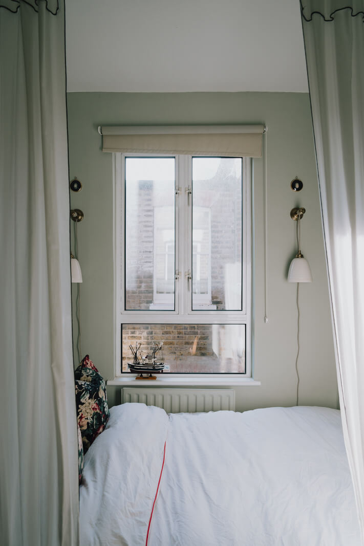 A Carefully Restored Edwardian Apartment with a Garden 14 tiny bedroom with curtains