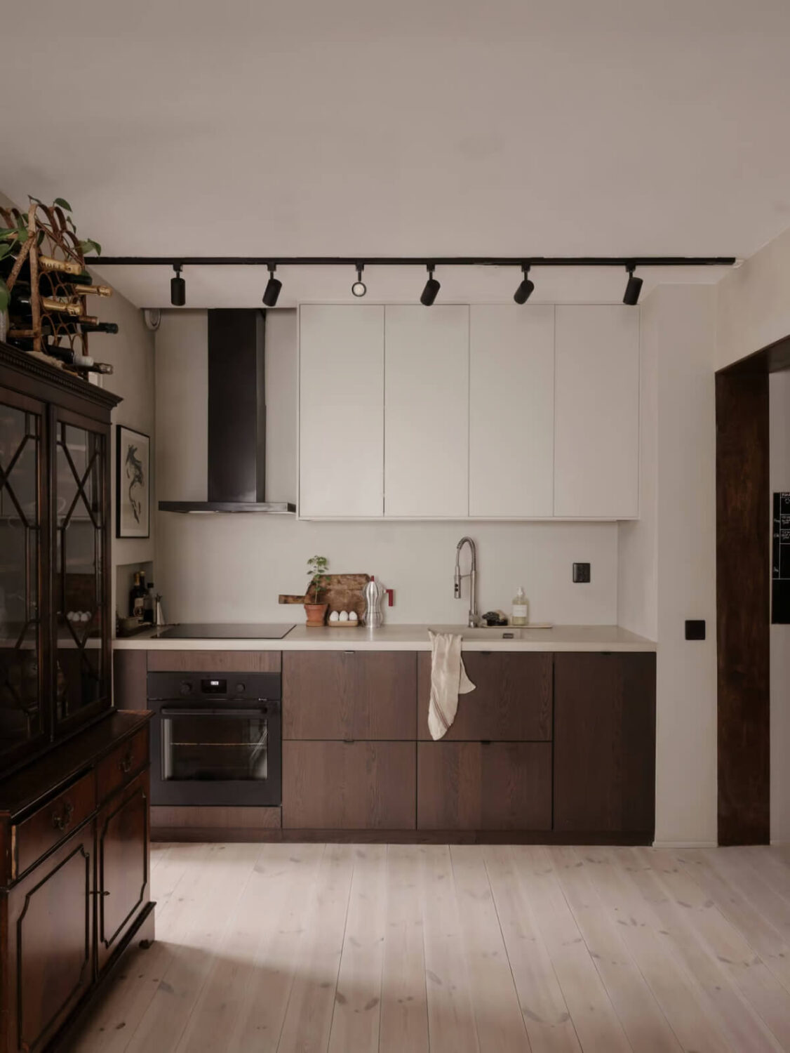 Limewash Walls in Muted Tones in a Swedish Apartment 8 two tone kitchen cabinets