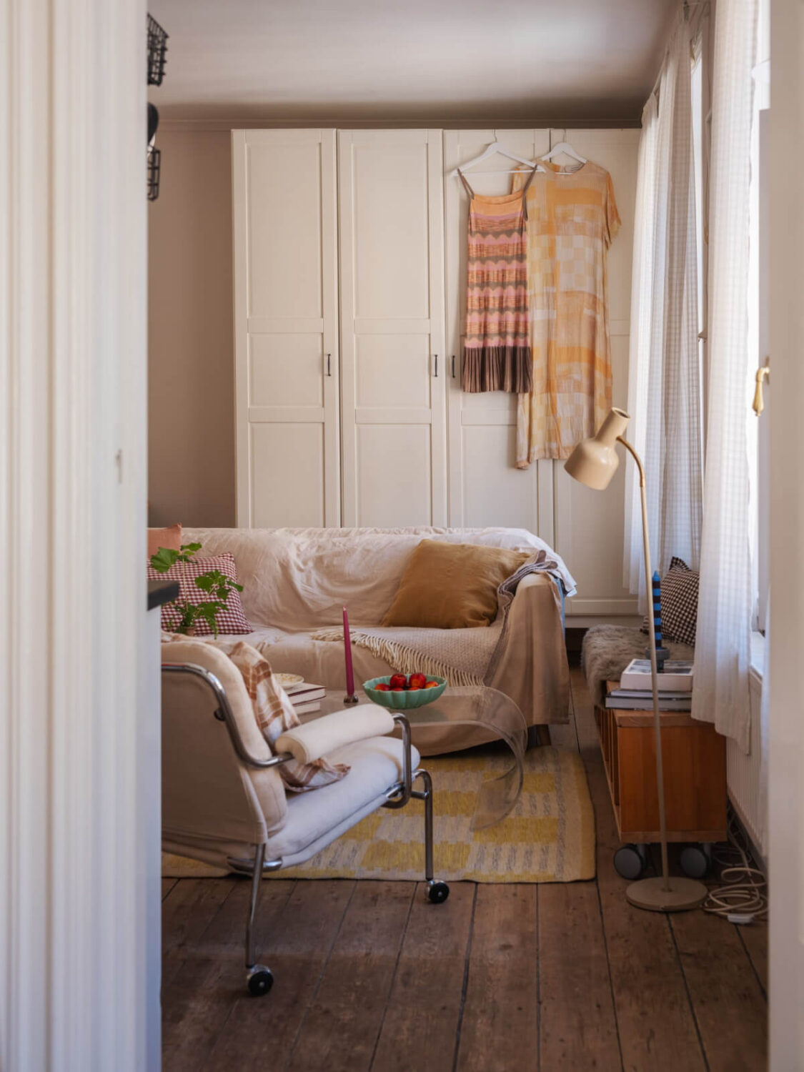 A Small Apartment with Rustic Floorboards and Beige Walls 14 view into living room rustic floorboards wardrobes