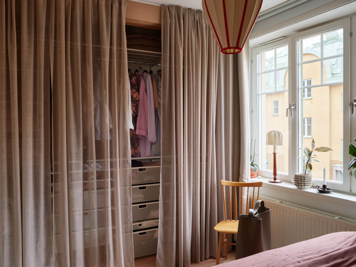 A Green Kitchen and a Pink Bedroom in a Charming Apartment 16 wardrobes behind sheer curtains