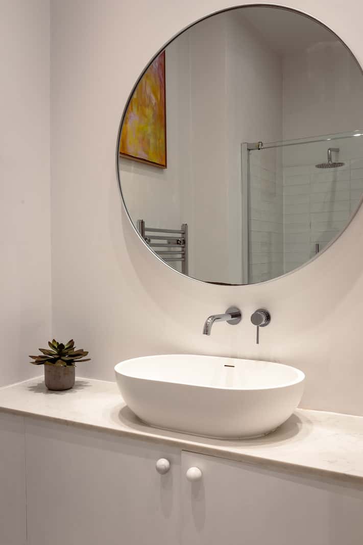 A Corner Apartment with Large Windows in a Former London Pub 17 white bathroom large round mirror