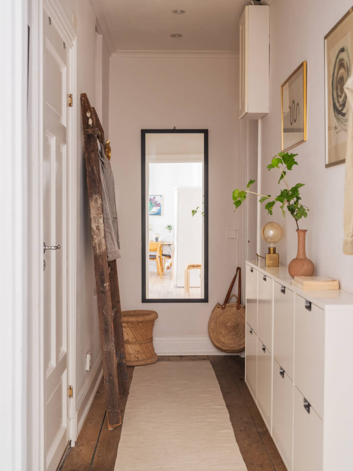 A Small Apartment with Rustic Floorboards and Beige Walls 21 white hall ikea shoe storage rustic floorboards