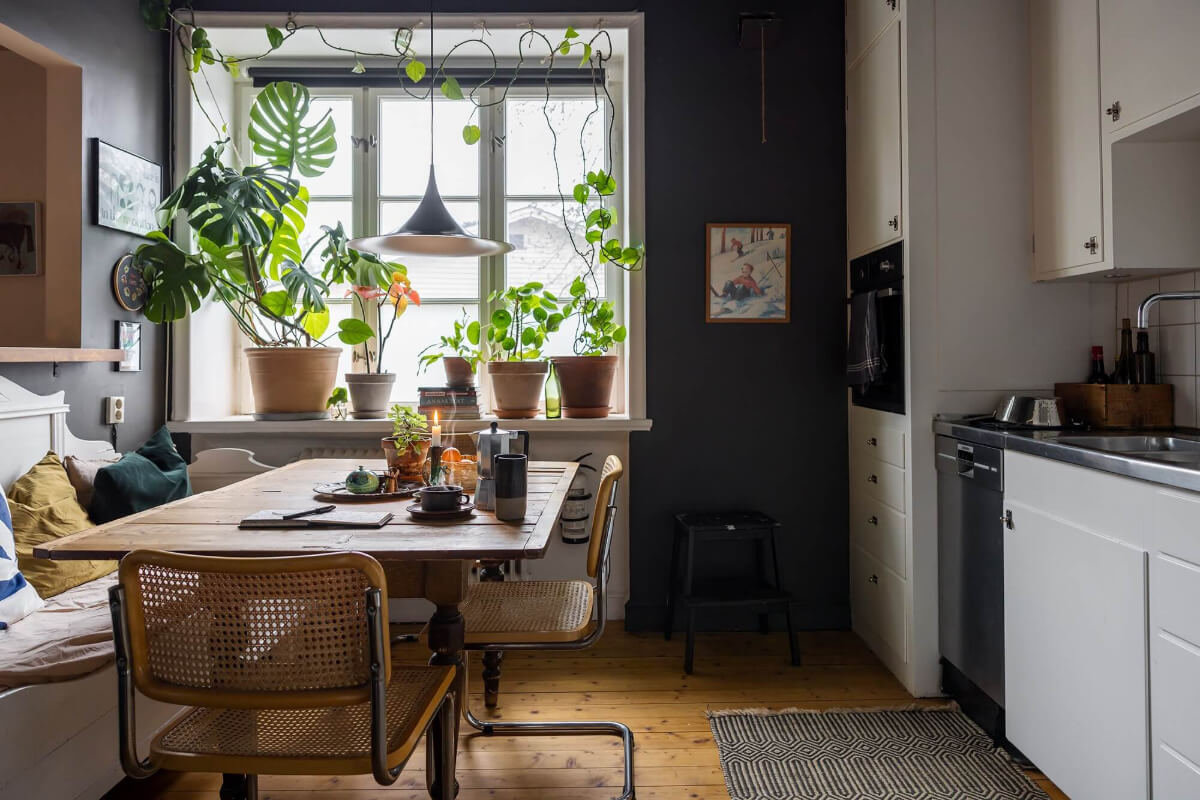 A Cozy Studio Apartment in a 1930s Building 7 white kitchen cabinets dark walls and dining table