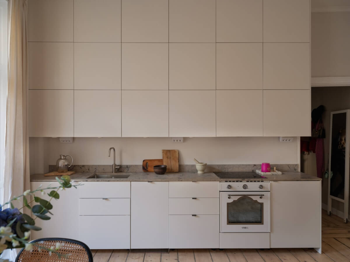 A Small Apartment with Contemporary Furniture in a 19th-Century Building 9 white kitchen triple row upper cabinets