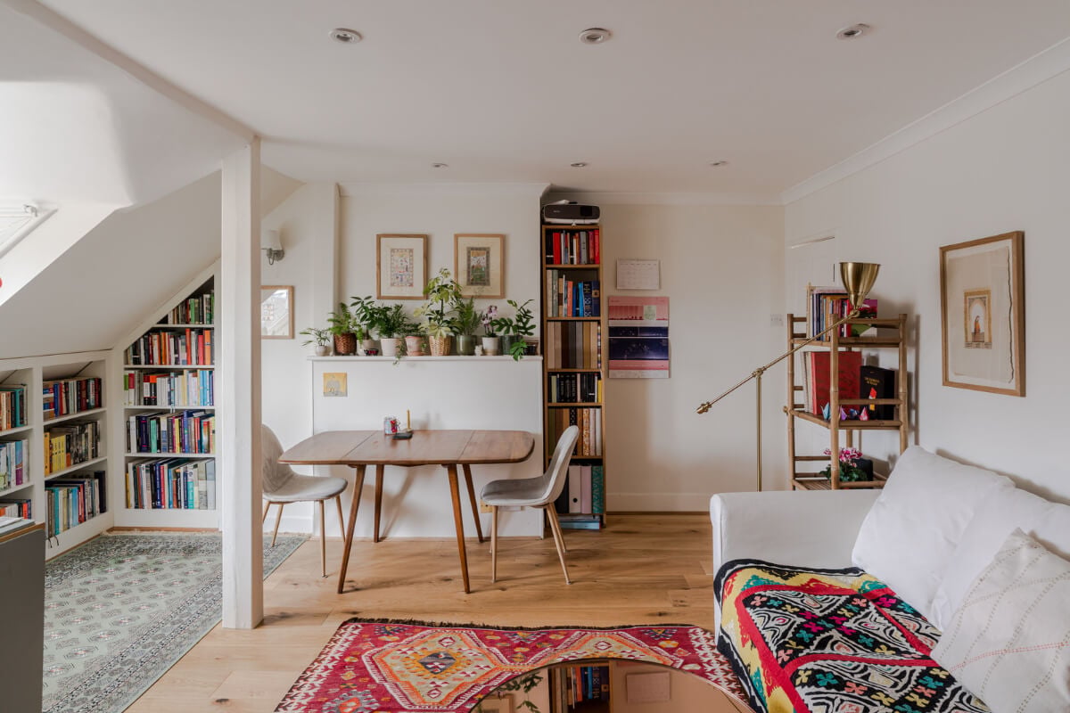 A Light-Filled London Attic Apartment with Cozy Nooks 2 white-living-room-slanted-ceiling