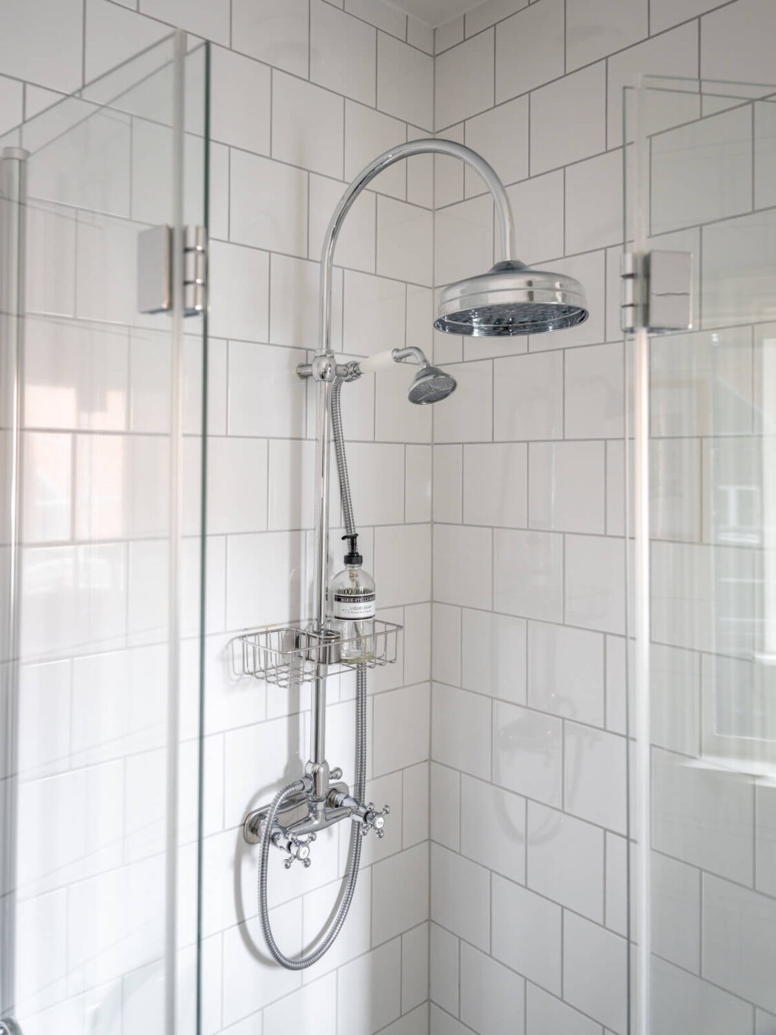 Turn-of-the-Century Charm Meets Modern Comfort in a Swedish House 23 white tiled shower