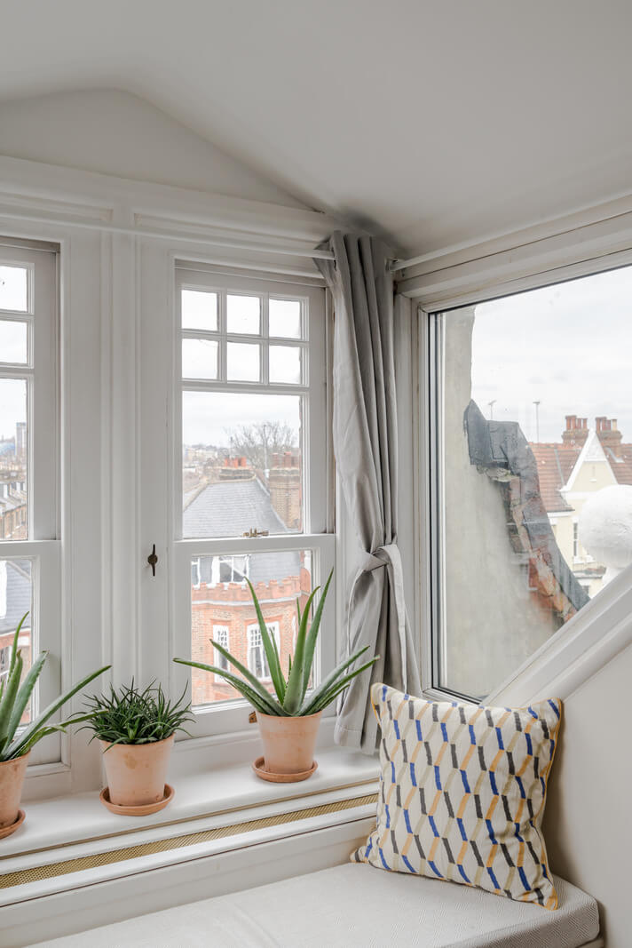 A Light-Filled London Attic Apartment with Cozy Nooks 19 window seat