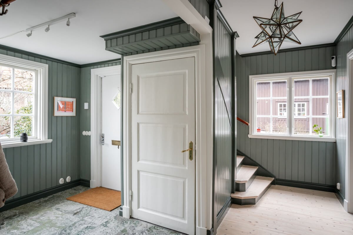 Turn-of-the-Century Charm Meets Modern Comfort in a Swedish House 30 wood paneled hall stone floor