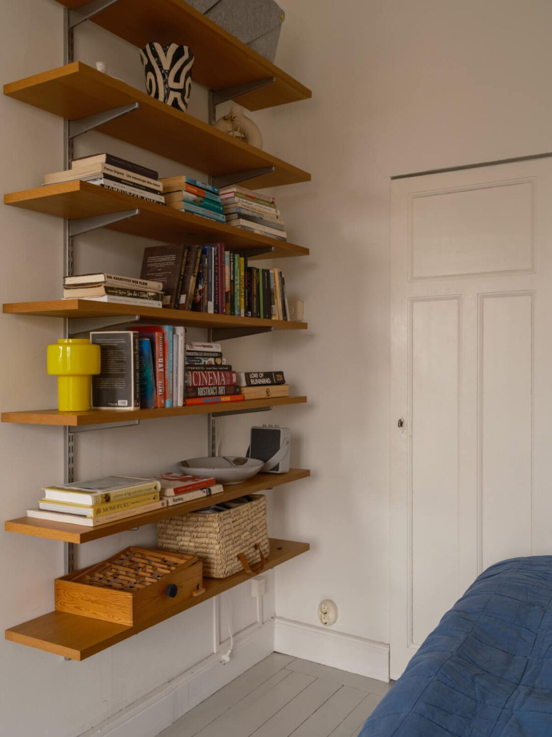 A Studio Apartment with an Exposed Brick Wall 12 wooden shelves