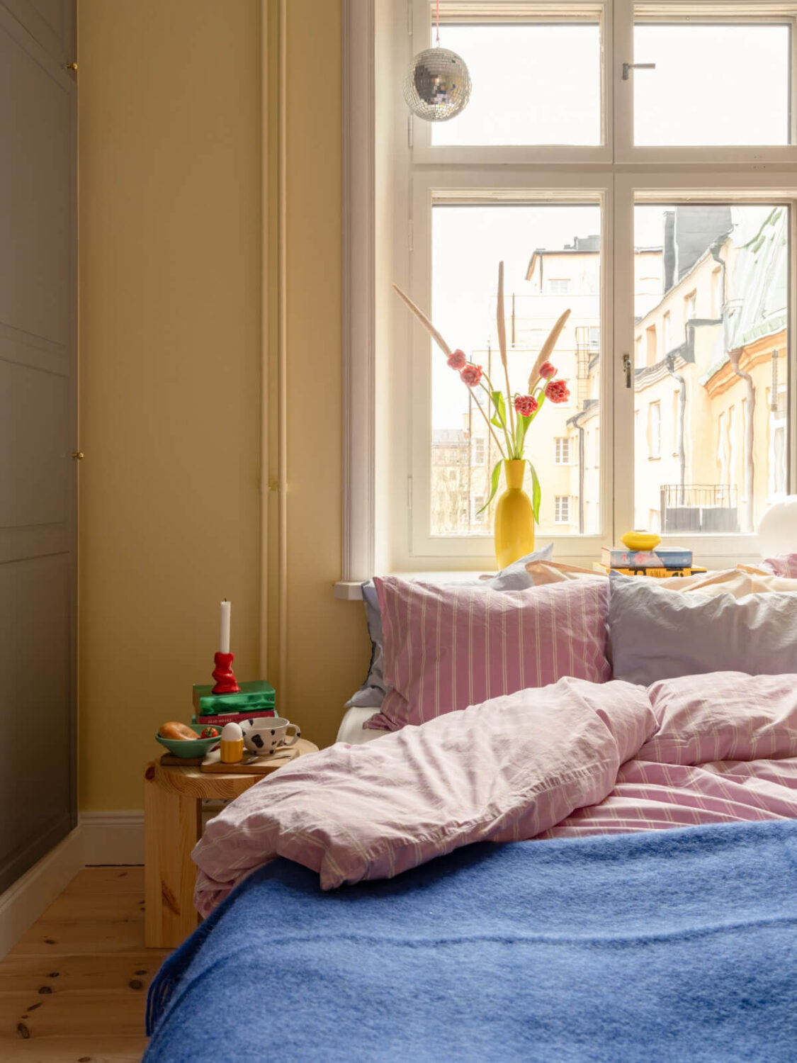Cheerful Color Accents in a One-Bedroom Stockholm Apartment 16 yellow bedroom detail